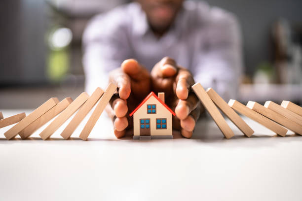 Small little property and a man with his hands over it