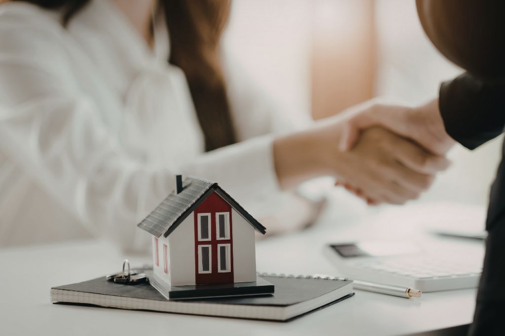 Handshake over property documents representing property insurance