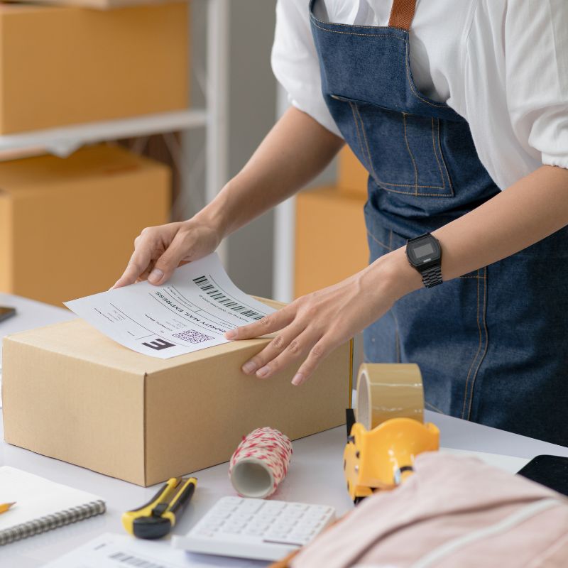 Business packaging products for dispatch, representing Products Liability Insurance for goods supplied to customers.